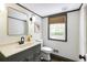 Charming bathroom features an ornate mirror, a black faucet, neutral paint, and a window with a wooded view at 3707 Dunwoody Club Dr, Atlanta, GA 30350