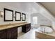 This modern bathroom has dual sinks, a soaking tub and neutral finishes at 3707 Dunwoody Club Dr, Atlanta, GA 30350