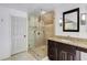 Bathroom features a shower with glass door and dark vanity at 3707 Dunwoody Club Dr, Atlanta, GA 30350