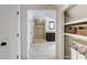 Bright bathroom with glass walk-in shower, and an adjoining walk-in closet with shelving at 3707 Dunwoody Club Dr, Atlanta, GA 30350