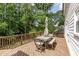 Large deck with table, bench, and chairs overlooking private, wooded backyard at 3707 Dunwoody Club Dr, Atlanta, GA 30350