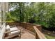 Relaxing outdoor seating area on a wooden deck with a scenic backyard view at 3707 Dunwoody Club Dr, Atlanta, GA 30350