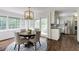 Cozy dining area with natural light, complemented by white cabinets and stainless steel appliances in adjacent kitchen at 3707 Dunwoody Club Dr, Atlanta, GA 30350