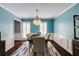 Light-filled dining room with a statement chandelier and designer rug at 3707 Dunwoody Club Dr, Atlanta, GA 30350