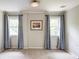 Versatile empty room with neutral paint, plush carpet, and dual windows with tree views at 3707 Dunwoody Club Dr, Atlanta, GA 30350
