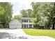 Two-story home with black shutters, light yellow siding, a well-manicured lawn and mature trees at 3707 Dunwoody Club Dr, Atlanta, GA 30350