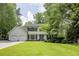Charming two-story home featuring a well-manicured lawn, symmetrical design, and a welcoming blue front door at 3707 Dunwoody Club Dr, Atlanta, GA 30350