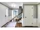 Hallway with hardwood floors, white trim, neutral grey paint, and views into the dining room at 3707 Dunwoody Club Dr, Atlanta, GA 30350
