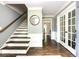 Entryway featuring hardwood floors, white trim, staircase, and a doorway with glass french doors at 3707 Dunwoody Club Dr, Atlanta, GA 30350