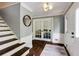 Inviting foyer boasts hardwood floors, staircase, fresh paint and stylish lighting fixture at 3707 Dunwoody Club Dr, Atlanta, GA 30350