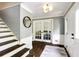 Entryway with hardwood floors, staircase, a round mirror, and a doorway with glass french doors at 3707 Dunwoody Club Dr, Atlanta, GA 30350