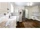 Well-lit kitchen featuring stainless steel fridge, granite countertops, and modern fixtures at 3707 Dunwoody Club Dr, Atlanta, GA 30350