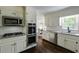 Well-lit kitchen featuring white cabinets, stainless steel appliances, granite countertops, and subway tile backsplash at 3707 Dunwoody Club Dr, Atlanta, GA 30350