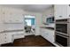 Bright kitchen boasts white cabinets, stainless steel appliances, granite countertops, and a subway tile backsplash at 3707 Dunwoody Club Dr, Atlanta, GA 30350