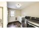 Functional laundry room with modern washer and dryer, storage, and a door to the backyard at 3707 Dunwoody Club Dr, Atlanta, GA 30350
