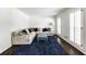 Bright living room with plush seating, a blue rug, hardwood flooring, and shuttered windows at 3707 Dunwoody Club Dr, Atlanta, GA 30350