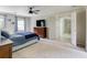 Bright main bedroom features a dresser, neutral paint, a ceiling fan, and ensuite bathroom access at 3707 Dunwoody Club Dr, Atlanta, GA 30350