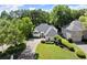 An aerial view of a well-maintained home with manicured landscaping and mature trees in a suburban neighborhood at 5120 Falcon Chase Ln, Atlanta, GA 30342