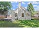 Lush backyard featuring green grass and a charming white brick exterior with large windows at 5120 Falcon Chase Ln, Atlanta, GA 30342