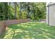 Large backyard featuring a well-maintained lawn, privacy fence, and mature trees at 5120 Falcon Chase Ln, Atlanta, GA 30342