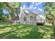 Expansive backyard featuring a lush lawn and a charming white brick exterior with an outdoor deck at 5120 Falcon Chase Ln, Atlanta, GA 30342