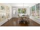 Bright dining area with hardwood floors, large windows, stylish chandelier, and backyard view at 5120 Falcon Chase Ln, Atlanta, GA 30342