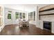 Sunlit dining area with stylish chandelier, built-in wine storage and hardwood floors at 5120 Falcon Chase Ln, Atlanta, GA 30342