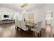 Formal dining area featuring hardwood floors, a modern light fixture, and seating for eight guests at 5120 Falcon Chase Ln, Atlanta, GA 30342