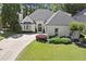 Charming painted brick home with manicured lawn, arched entry, and manicured landscaping at 5120 Falcon Chase Ln, Atlanta, GA 30342