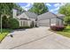 Charming painted brick home with an attached garage, manicured lawn, and basketball hoop at 5120 Falcon Chase Ln, Atlanta, GA 30342