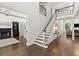 Elegant entry foyer featuring a staircase, hardwood floors, and views into the formal living spaces at 5120 Falcon Chase Ln, Atlanta, GA 30342