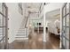 Bright foyer with hardwood floors, staircase, and views to a dining room and living room beyond at 5120 Falcon Chase Ln, Atlanta, GA 30342