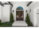 Close-up of a home's double front door, adorned with elegant lighting and manicured greenery at 5120 Falcon Chase Ln, Atlanta, GA 30342