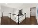 Hallway with dark hardwood floors, white trim, and access to multiple rooms at 5120 Falcon Chase Ln, Atlanta, GA 30342
