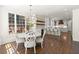 Modern eat-in kitchen with white cabinetry, dining area, and hardwood flooring at 5120 Falcon Chase Ln, Atlanta, GA 30342
