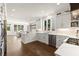 Open kitchen area with white cabinets, stainless steel appliances, hardwood floors, and adjacent dining area at 5120 Falcon Chase Ln, Atlanta, GA 30342