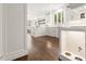 Bright kitchen area with white cabinets, stainless steel appliances, hardwood floors, and a pet feeding station at 5120 Falcon Chase Ln, Atlanta, GA 30342