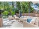 Outdoor patio with stone flooring, comfortable seating, and lush landscaping at 5120 Falcon Chase Ln, Atlanta, GA 30342