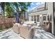 Outdoor patio with stone flooring, comfortable seating area, and wooden perimeter fence at 5120 Falcon Chase Ln, Atlanta, GA 30342