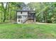Exterior view of home featuring a walkout basement, screened porch and expansive backyard at 315 N Fayette Dr, Fayetteville, GA 30214