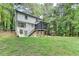 Rear exterior view of house showcasing the open green backyard and screened in porch at 315 N Fayette Dr, Fayetteville, GA 30214