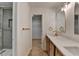 Bathroom featuring dual sinks, quartz countertop, and tile shower at 315 N Fayette Dr, Fayetteville, GA 30214
