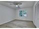 Bedroom featuring gray flooring, a ceiling fan, a double window and white closets at 315 N Fayette Dr, Fayetteville, GA 30214