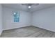 Bright bedroom with light gray flooring, ceiling fan, and a window providing natural light at 315 N Fayette Dr, Fayetteville, GA 30214