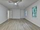 Spacious bedroom with hardwood floors, a ceiling fan, and two bright windows at 315 N Fayette Dr, Fayetteville, GA 30214