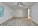 Bedroom featuring gray flooring, two windows, and a bathroom entrance at 315 N Fayette Dr, Fayetteville, GA 30214