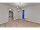An open-concept dining room with wood floors and modern lighting fixtures at 315 N Fayette Dr, Fayetteville, GA 30214