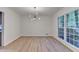 Bright dining room features modern chandelier, light wood floors and natural light at 315 N Fayette Dr, Fayetteville, GA 30214