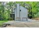 Side view of house highlighting garages, driveway, screened porch, and yard space at 315 N Fayette Dr, Fayetteville, GA 30214