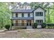 Charming two-story home with a welcoming front porch nestled amongst mature trees at 315 N Fayette Dr, Fayetteville, GA 30214